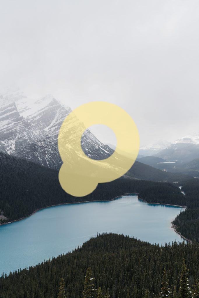 Широкоугольный снимок прозрачного замерзшего озера, окруженного горным пейзажем